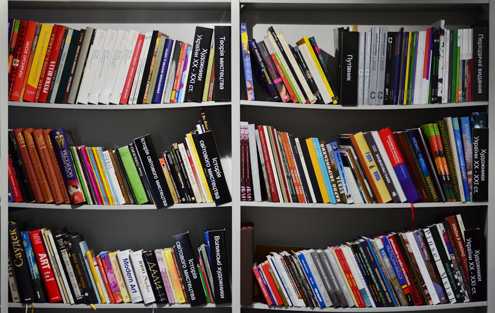 assorted books on a white shelf