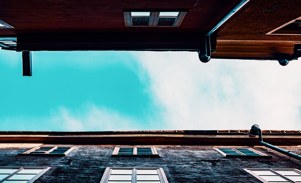 a tall building with lots of windows and a sky background