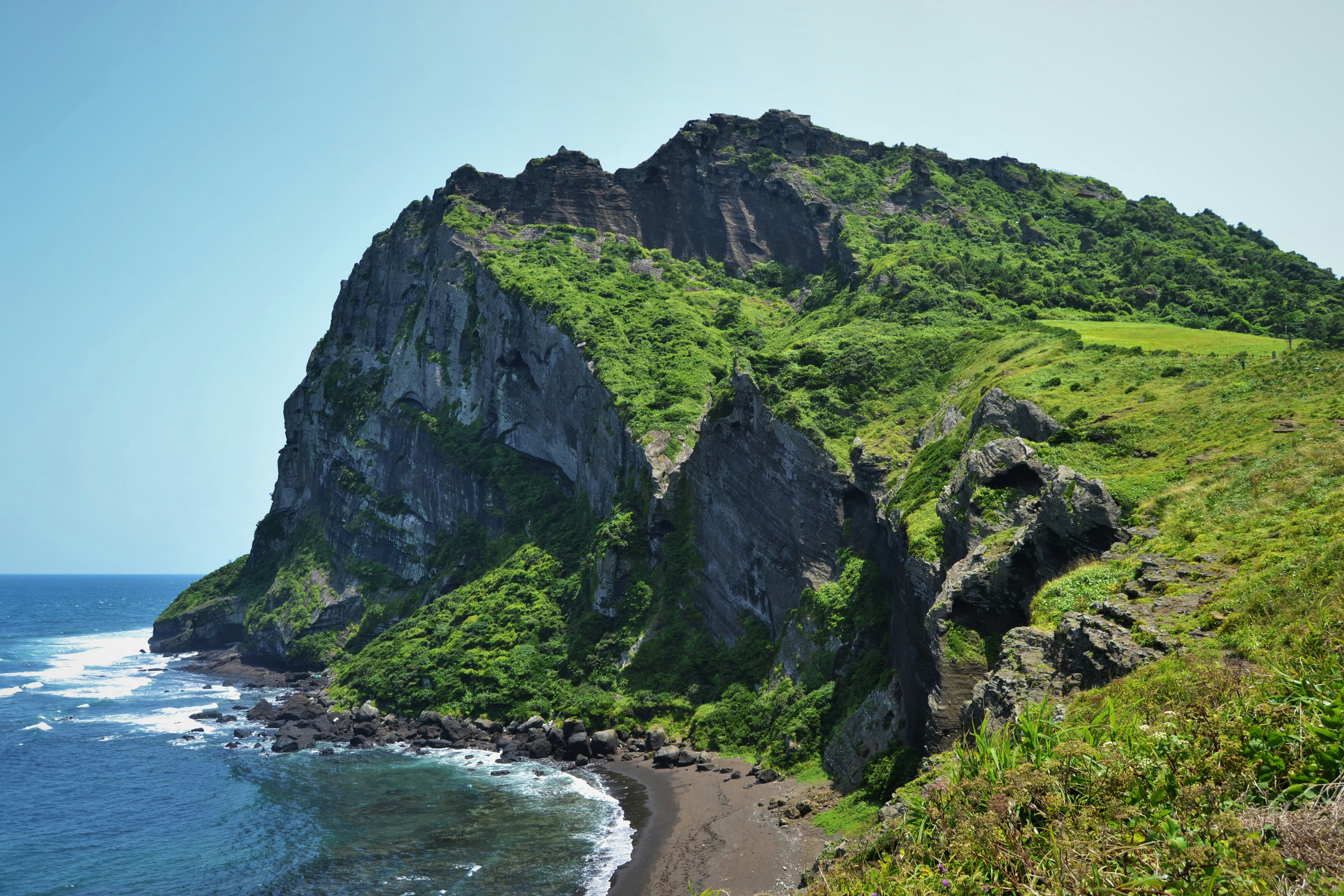 aerial photo of cliff beside sea south korea zoom background