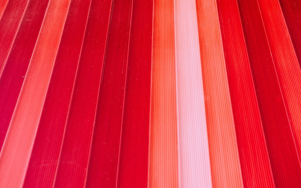 a close up of a red and white object