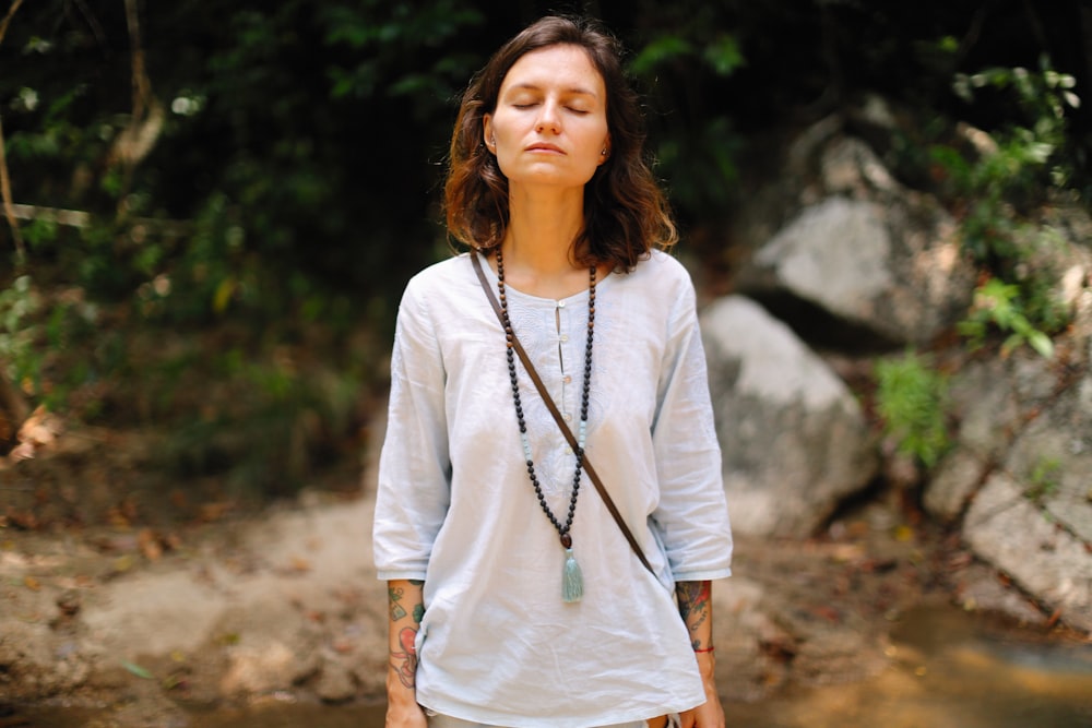 woman in white with her eyes closed