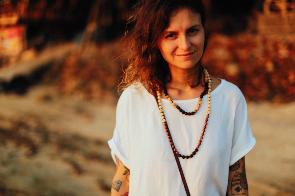 woman standing and smirking on dirt road