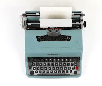 teal and black typewriter machine