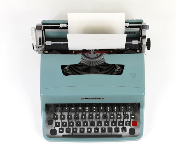 teal and black typewriter machine