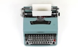teal and black typewriter machine