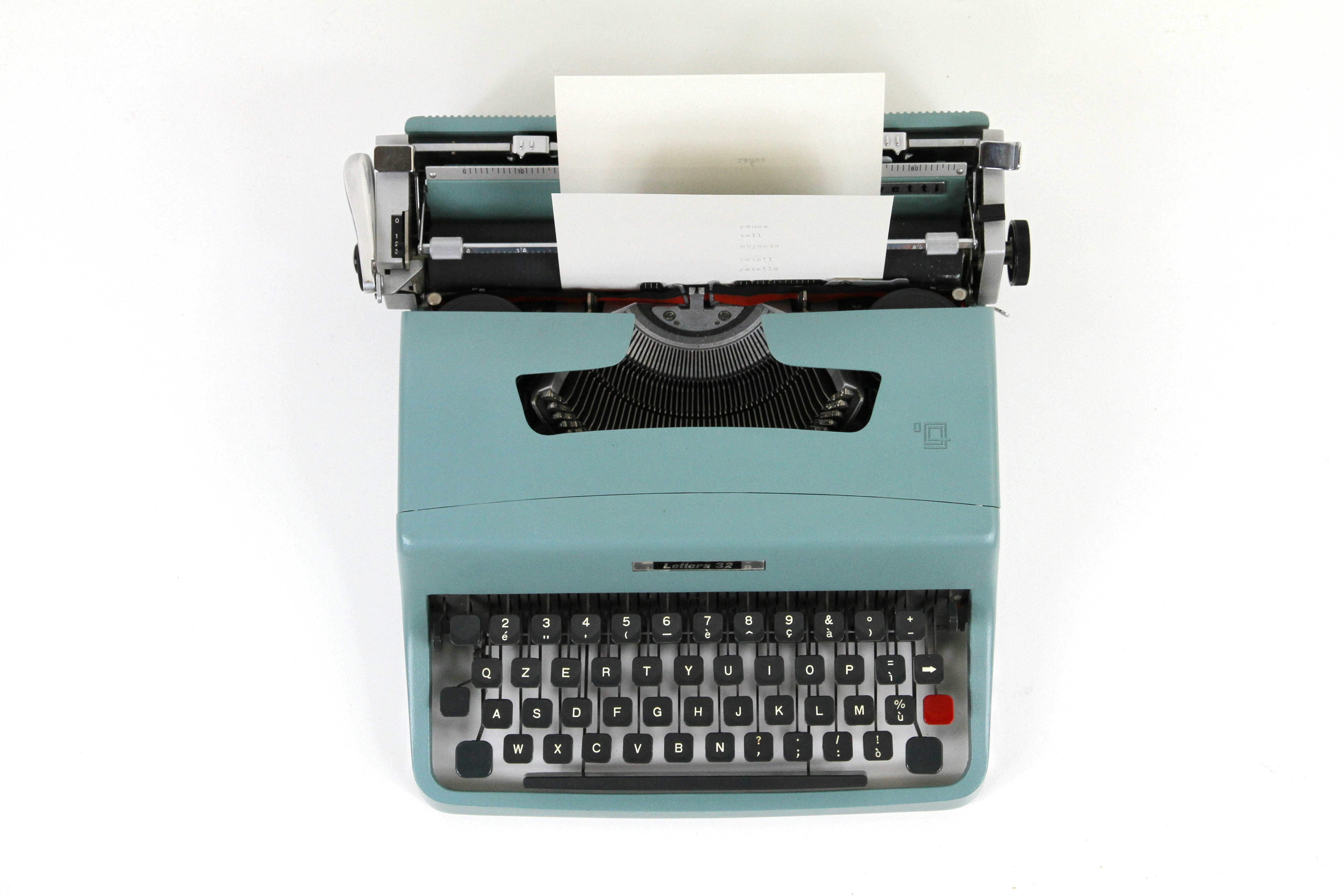 teal and black typewriter machine