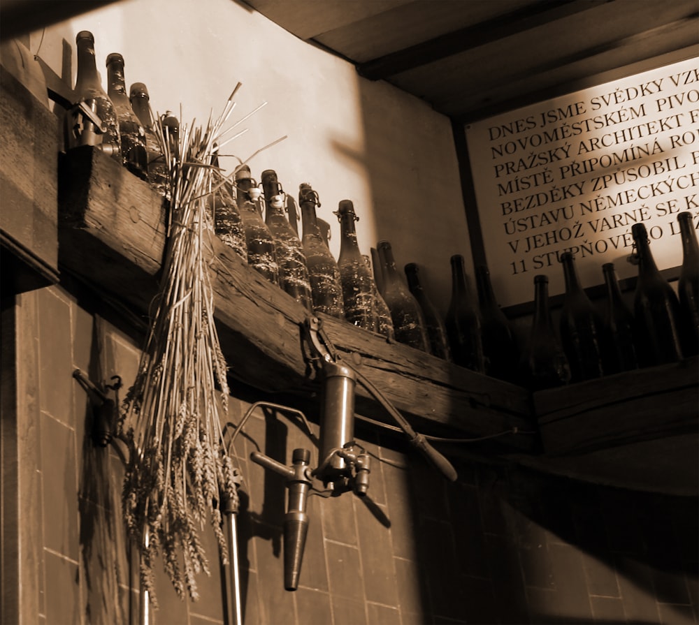 wine bottles on wooden wall shelf inside room