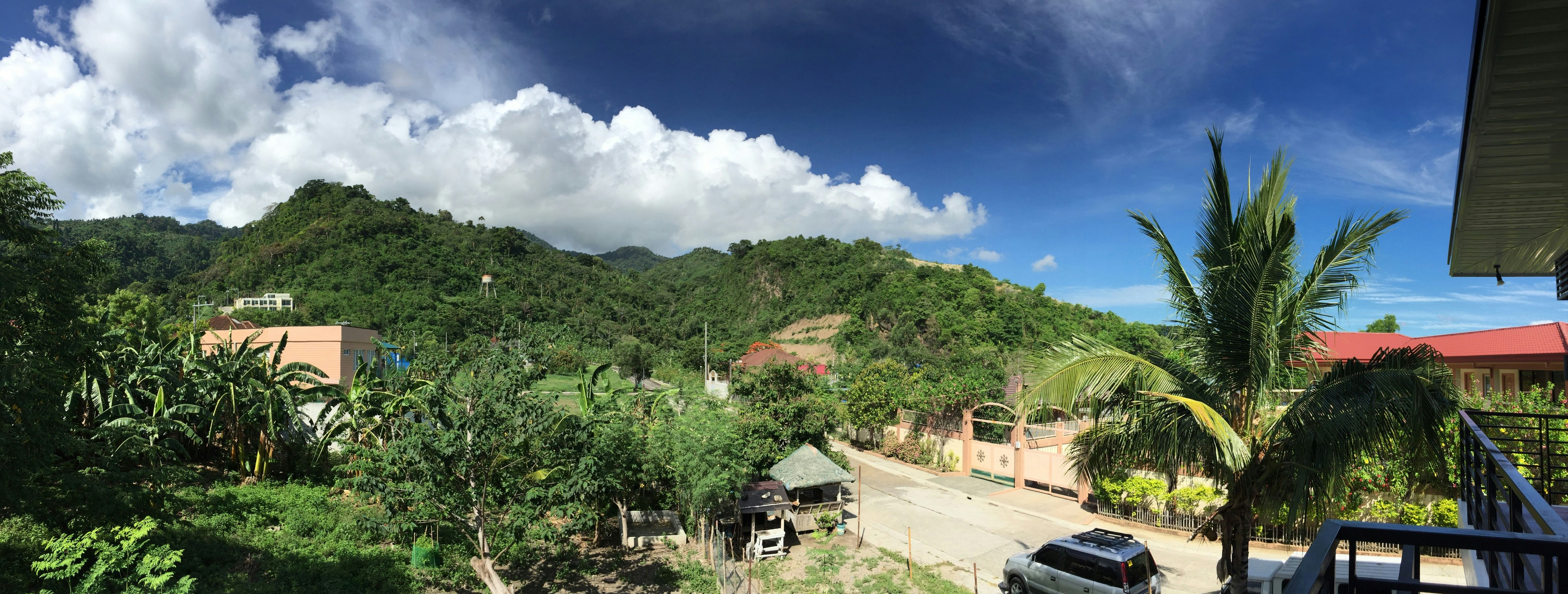 Colombian Andes mountains landscape with lush green valleys, bright daylight, airy open sky atmosphere