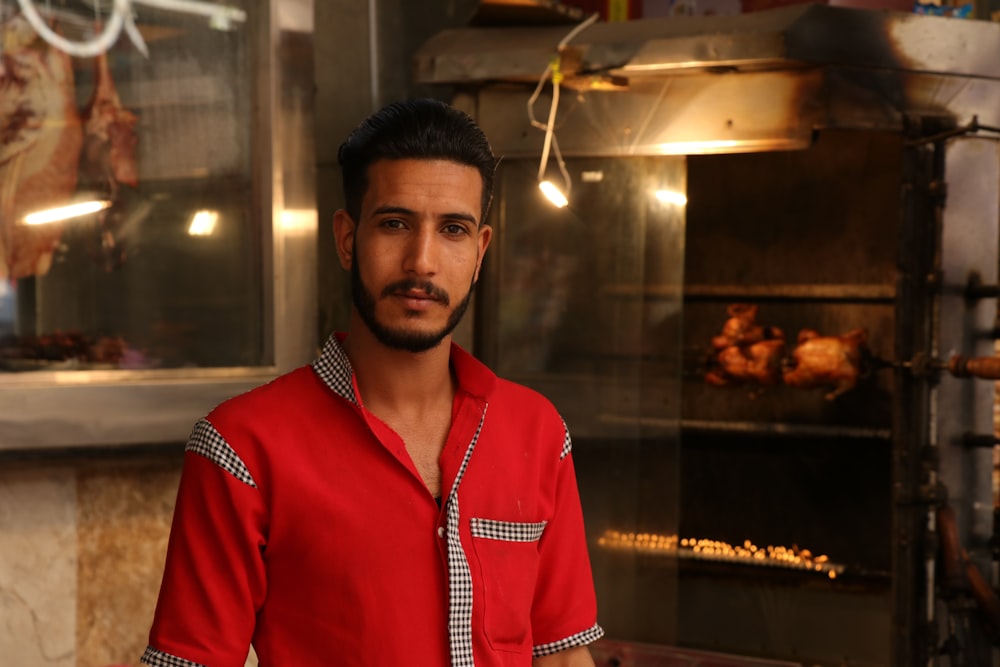 man standing near rotisserie