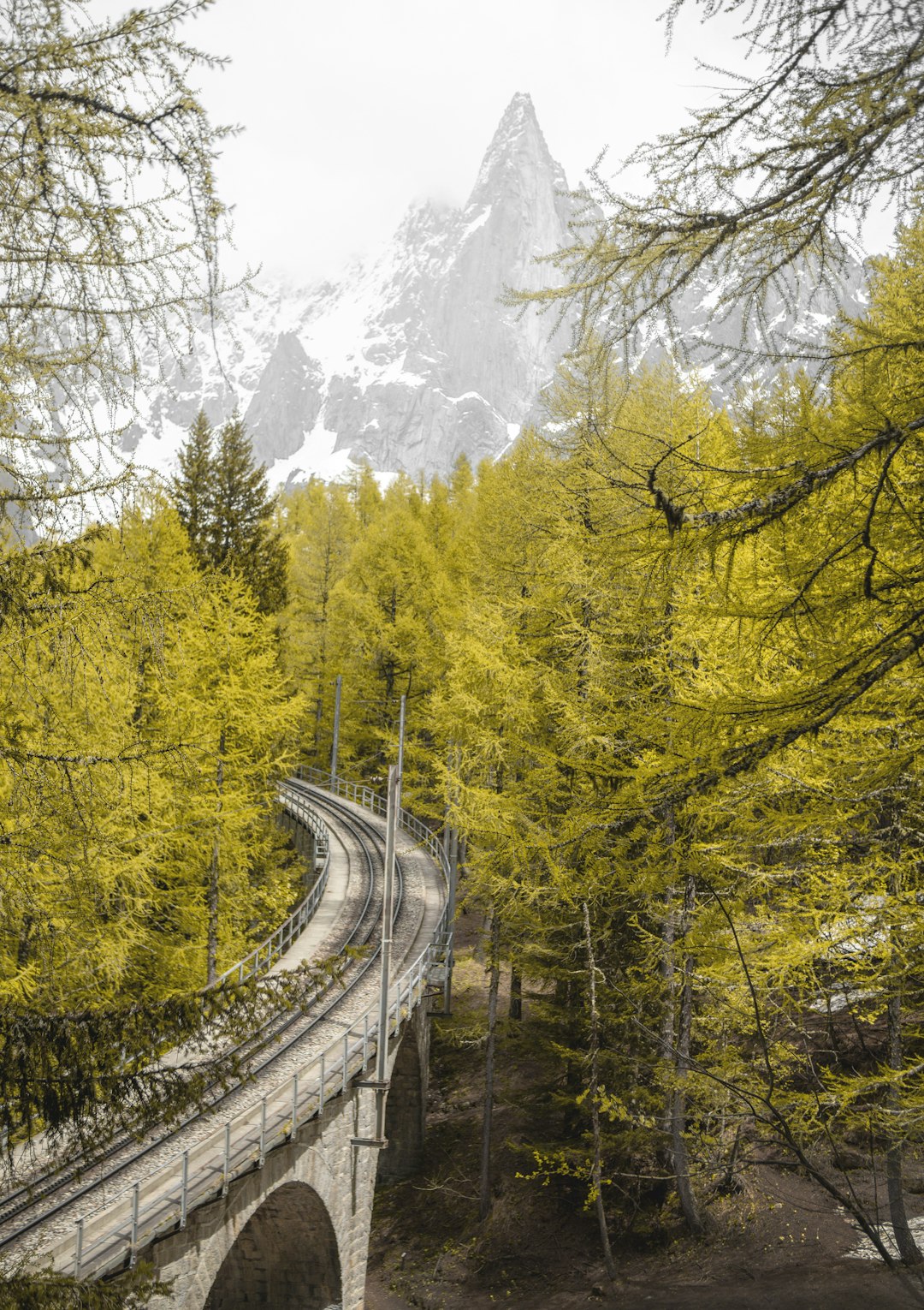 concrete bridge through snowy mountain