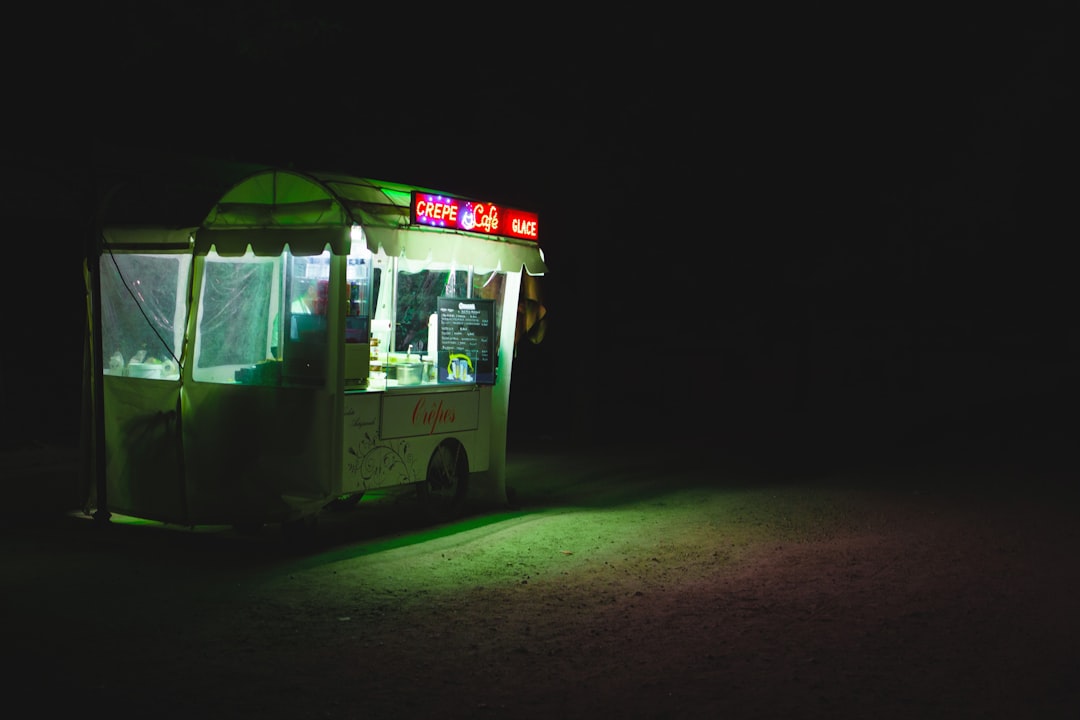 food cart with lights on during nighttime
