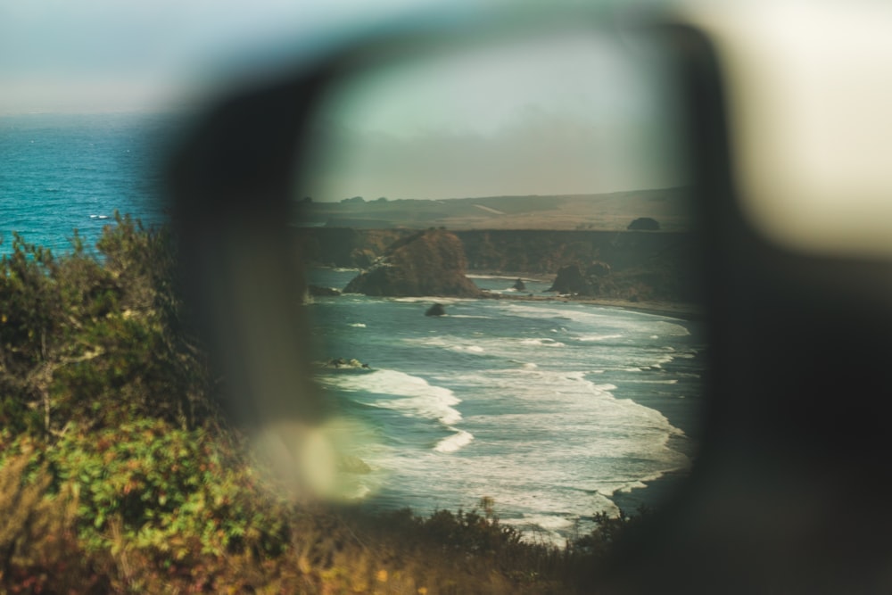 vehicle wing mirror photography of beach line