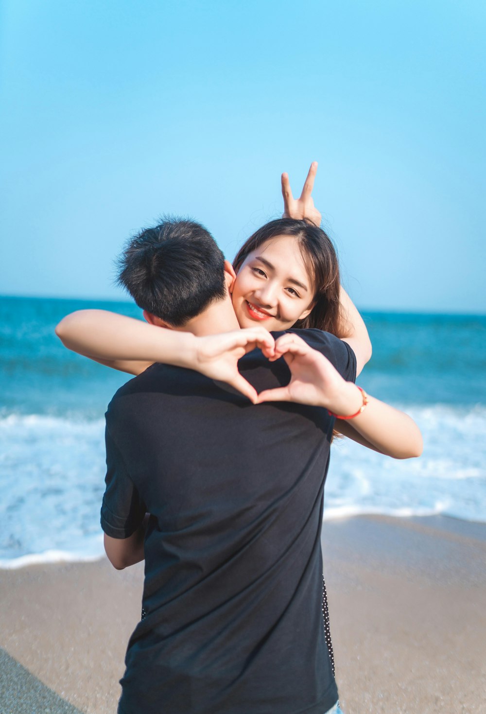 couple hugging standing on shore