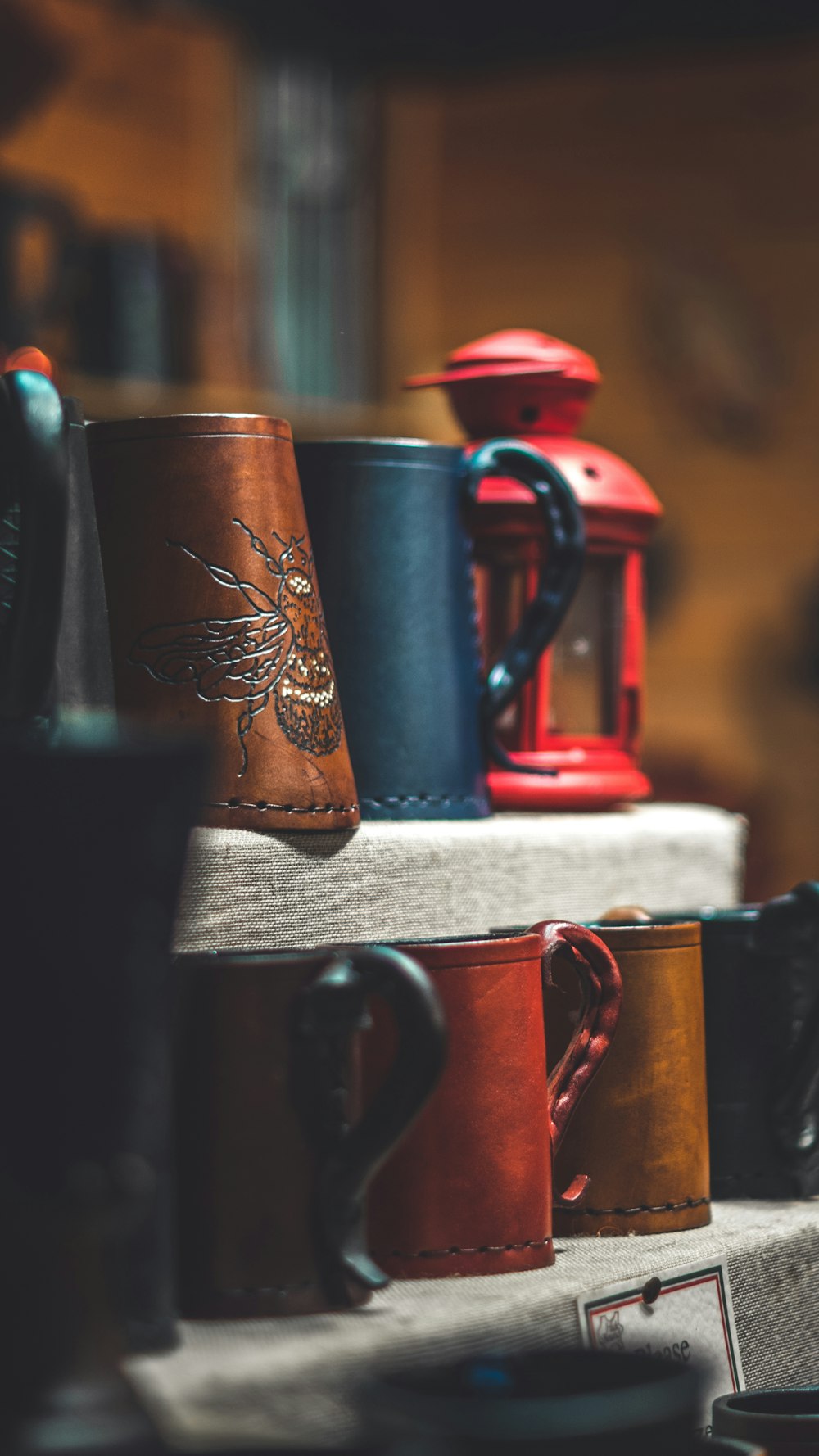 brown and black mugs on rack