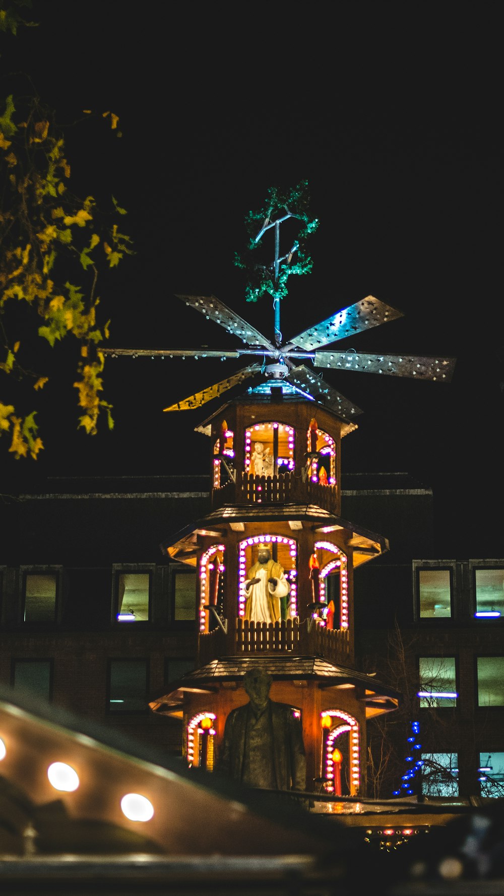 nativity scene with lighted string lights inside building during night time