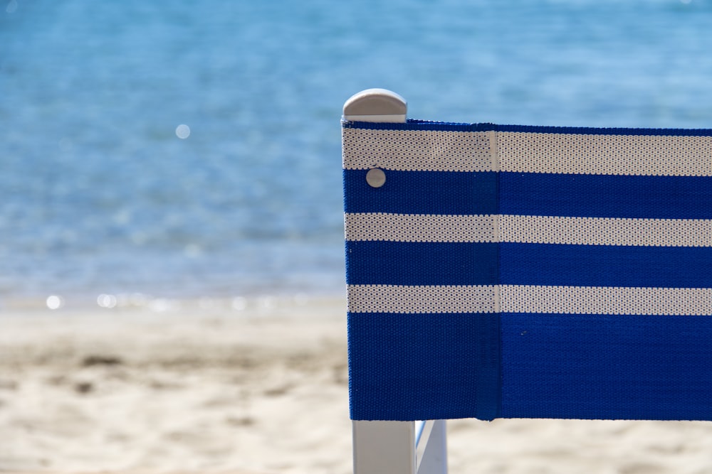 white and blue striped beach chair