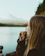 Close-up of a happy woman enjoying a gourmet snack from Terrasavor outdoors.