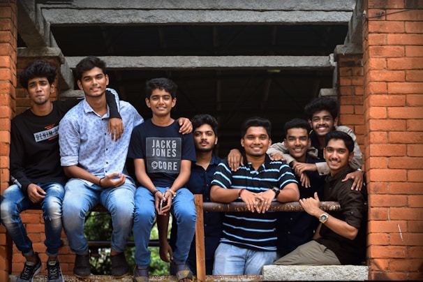 A lively group of young people smiling together in front of a historic Bartın street.