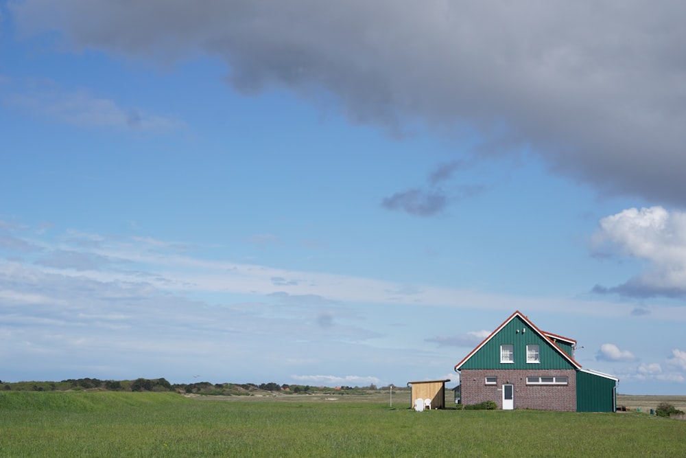 teal building on grass field