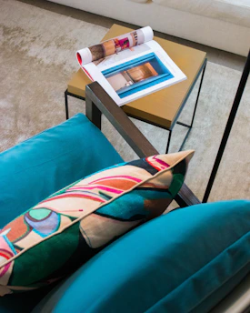 A vibrant living room setup featuring a cushioned, colorful chair inviting relaxation.