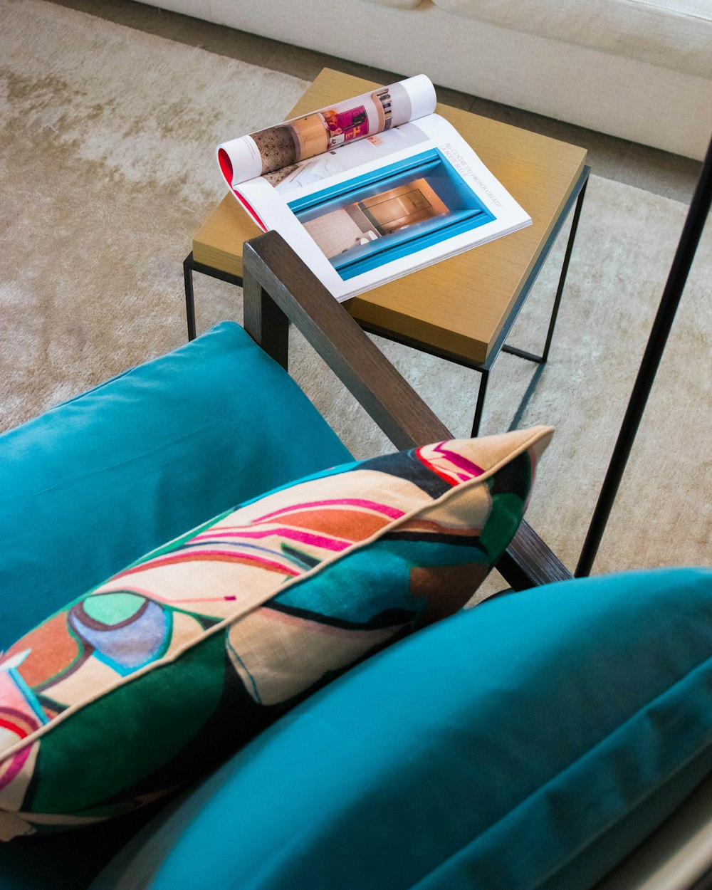 magazine on square brown wooden table