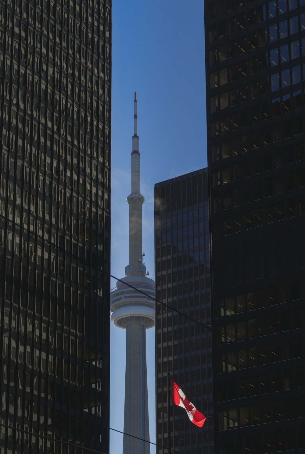 grey concrete tower in between high-rise buildings