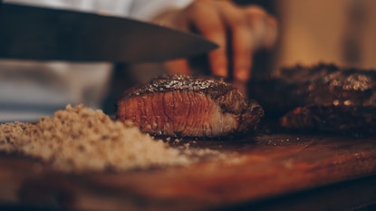 person cutting meat