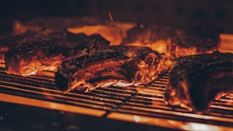 Grilled meats sizzling over open flames at a traditional Brazilian churrascaria.
