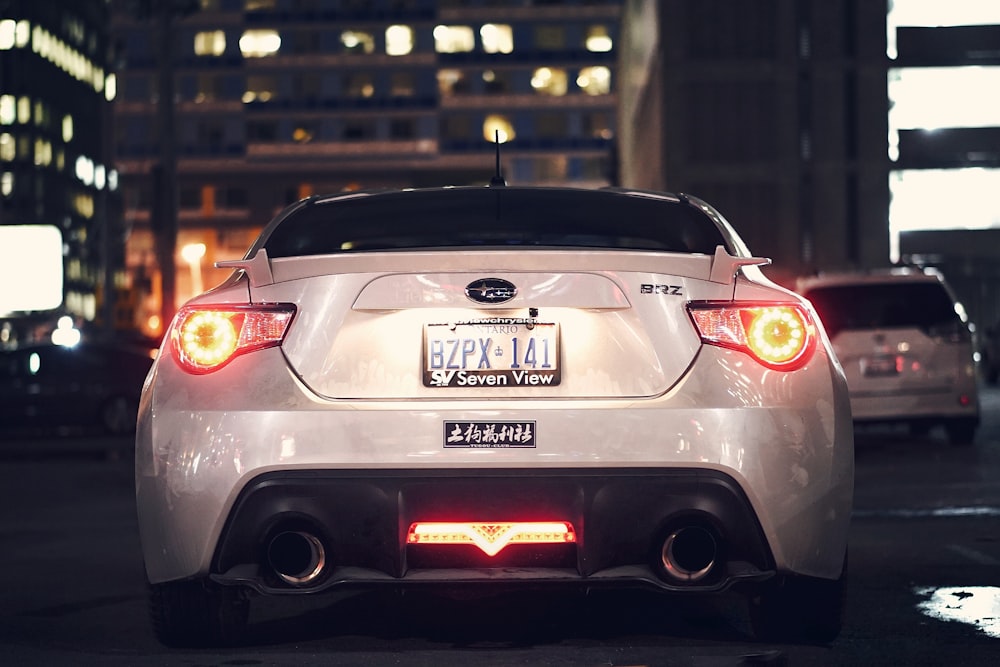 white Subaru car on the road near car