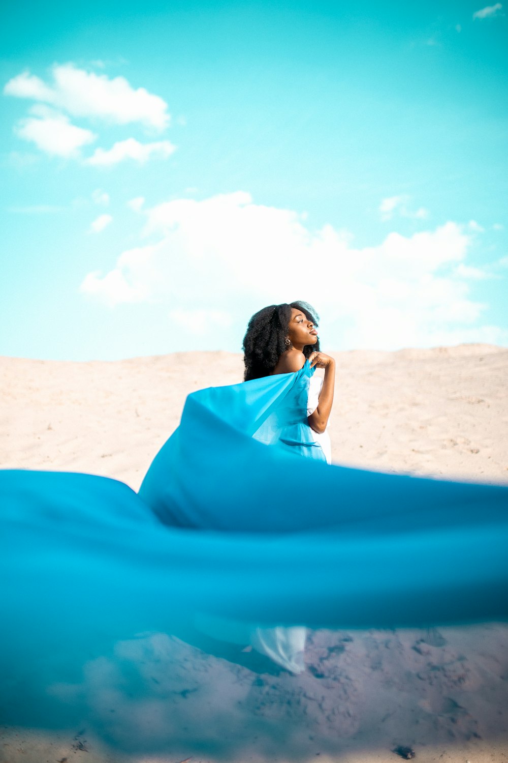 woman standing and holding floating dress