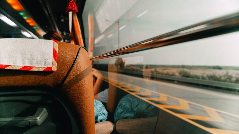 a woman sitting on a bus looking out the window