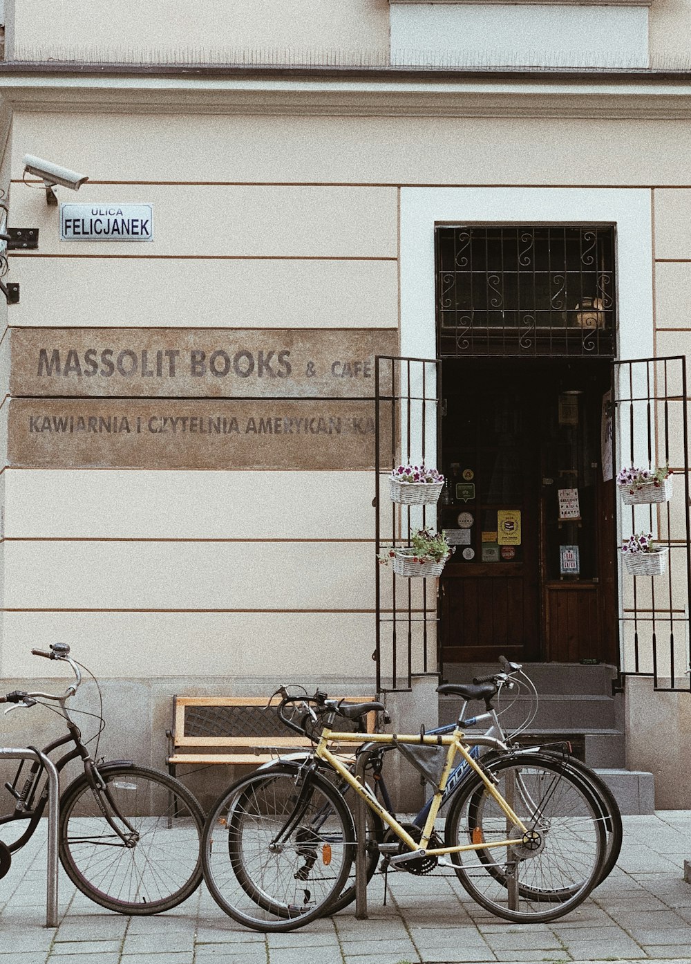 yellow bicycle parked in front of Massolit Books & Cafe