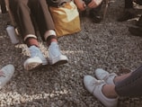 A person wearing shoes at a casual outdoor gathering.