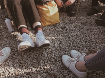 A person wearing shoes at a casual outdoor gathering.