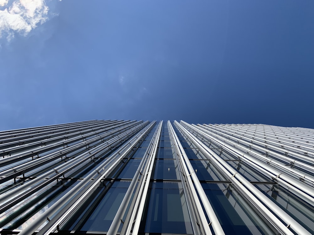 photo of gray building with blue window glass