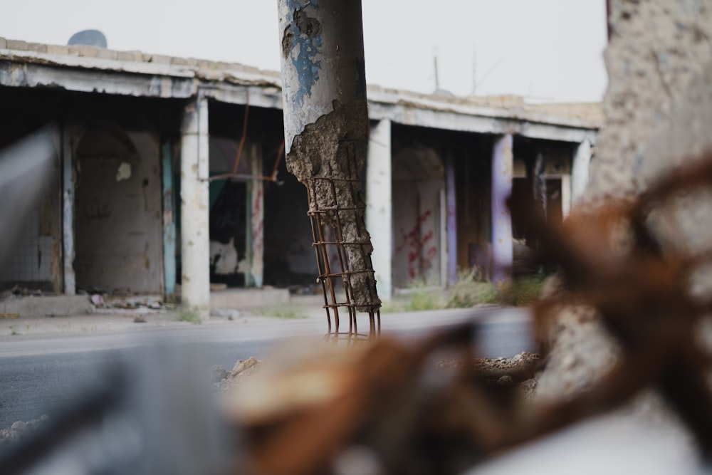 a wooden chair sitting on the side of a road