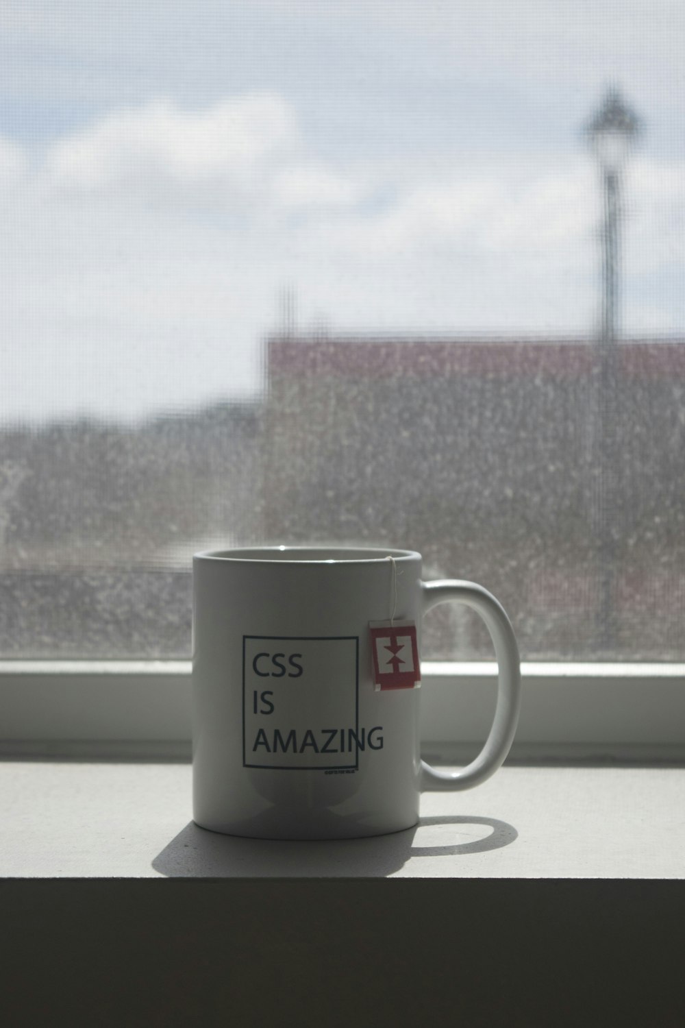 white and black ceramic mug