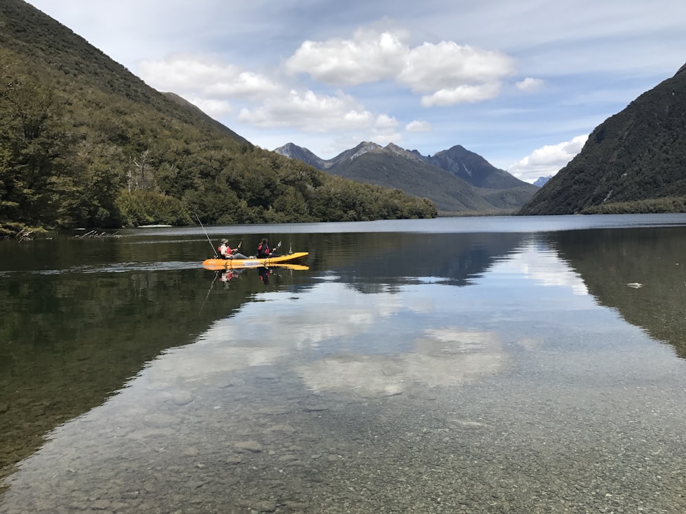 two person riding kayak near lake during daytime