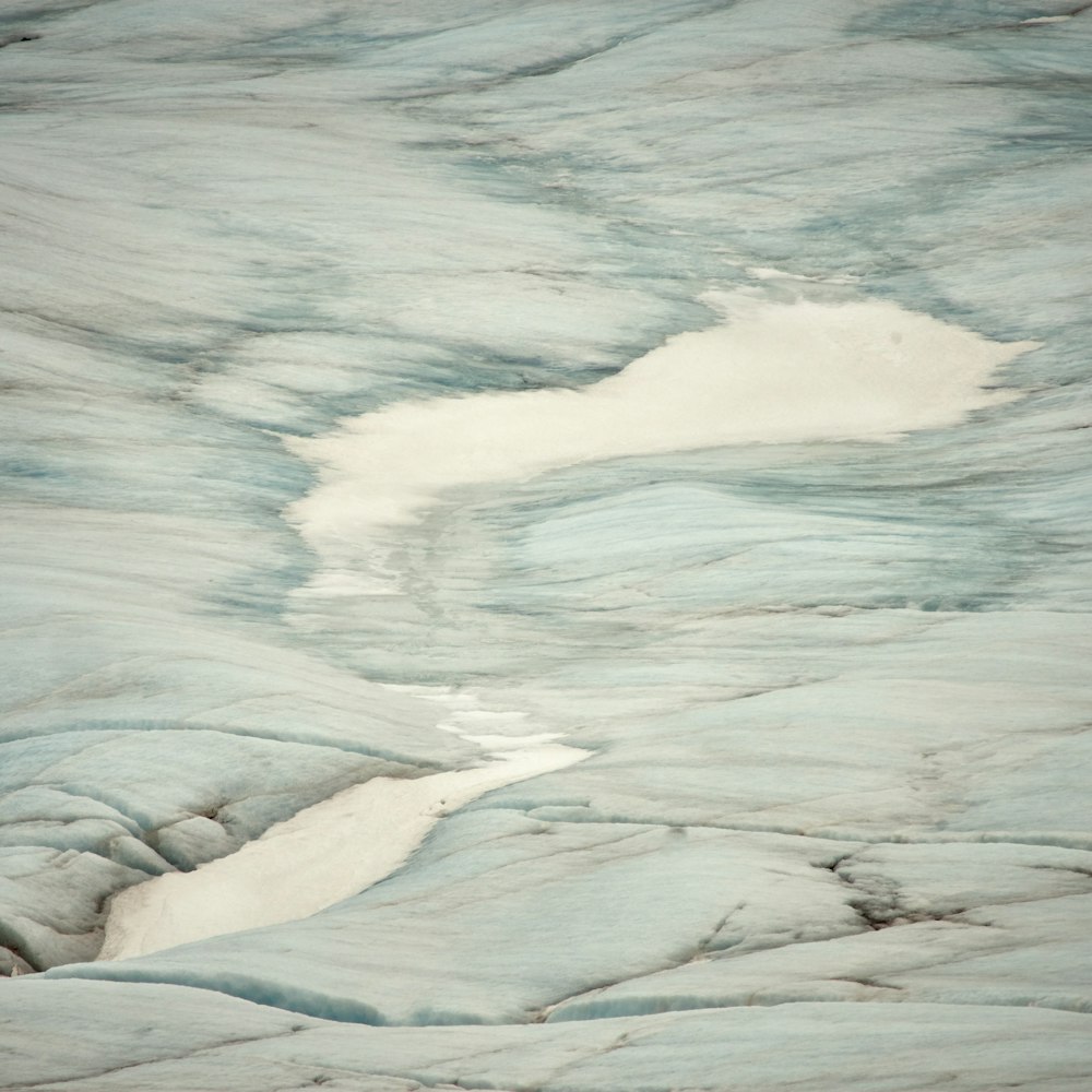 a small stream of water running through a glacier