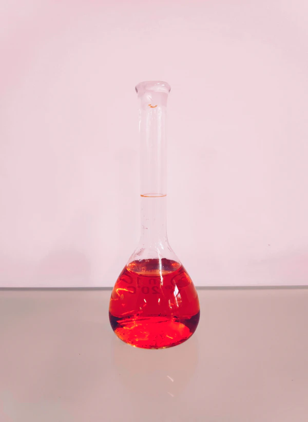 MALCO glass tube on white surface