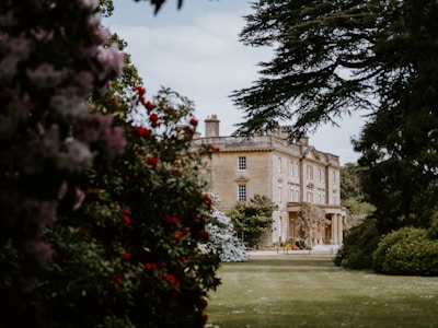 Elegant estate architecture framed by blooming flower beds in spring.