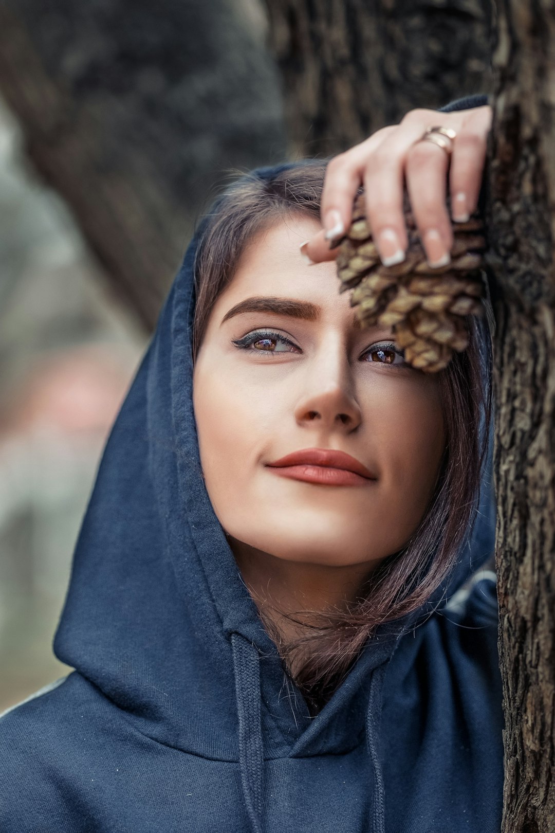 woman leaning tree