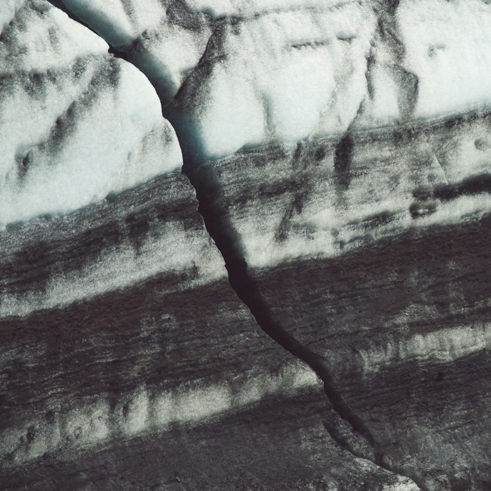 an aerial view of a glacier with snow on the ground