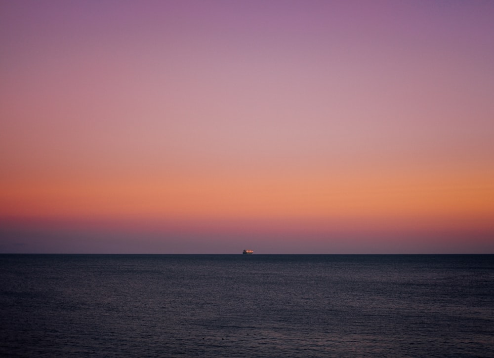 ship sailing at the sea during sunset