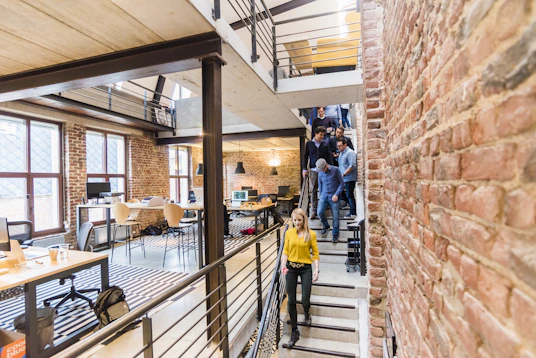 Young professional walking through a bright modern office workspace