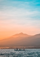 people riding on boat during golden hour