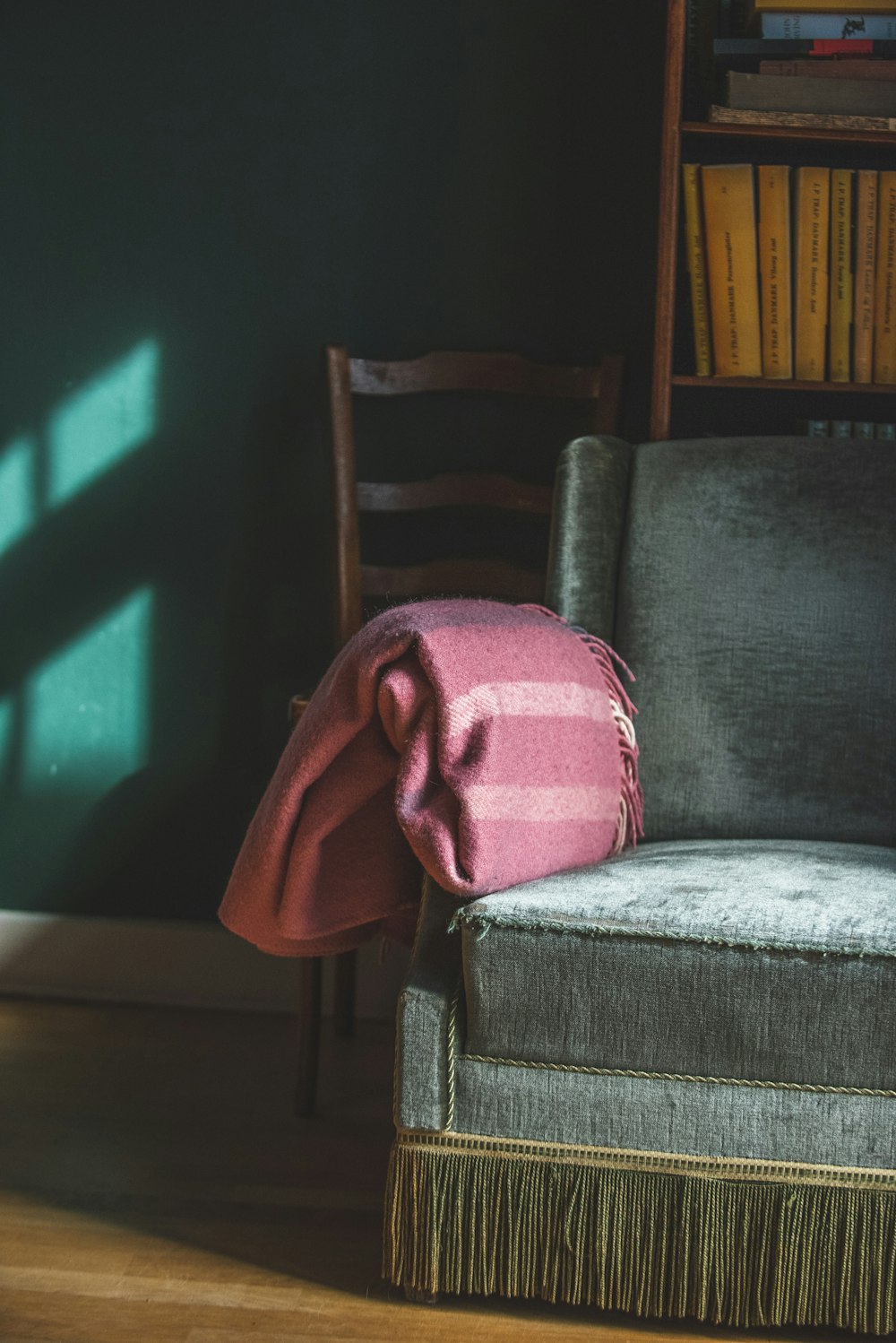red and pink striped blanket on sofa armchair
