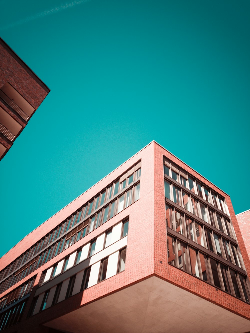 low-angle photography of red concrete building