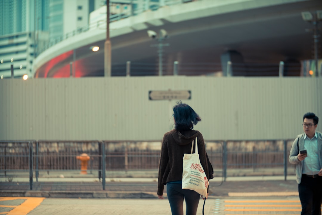 woman carrying white fabric tote bag