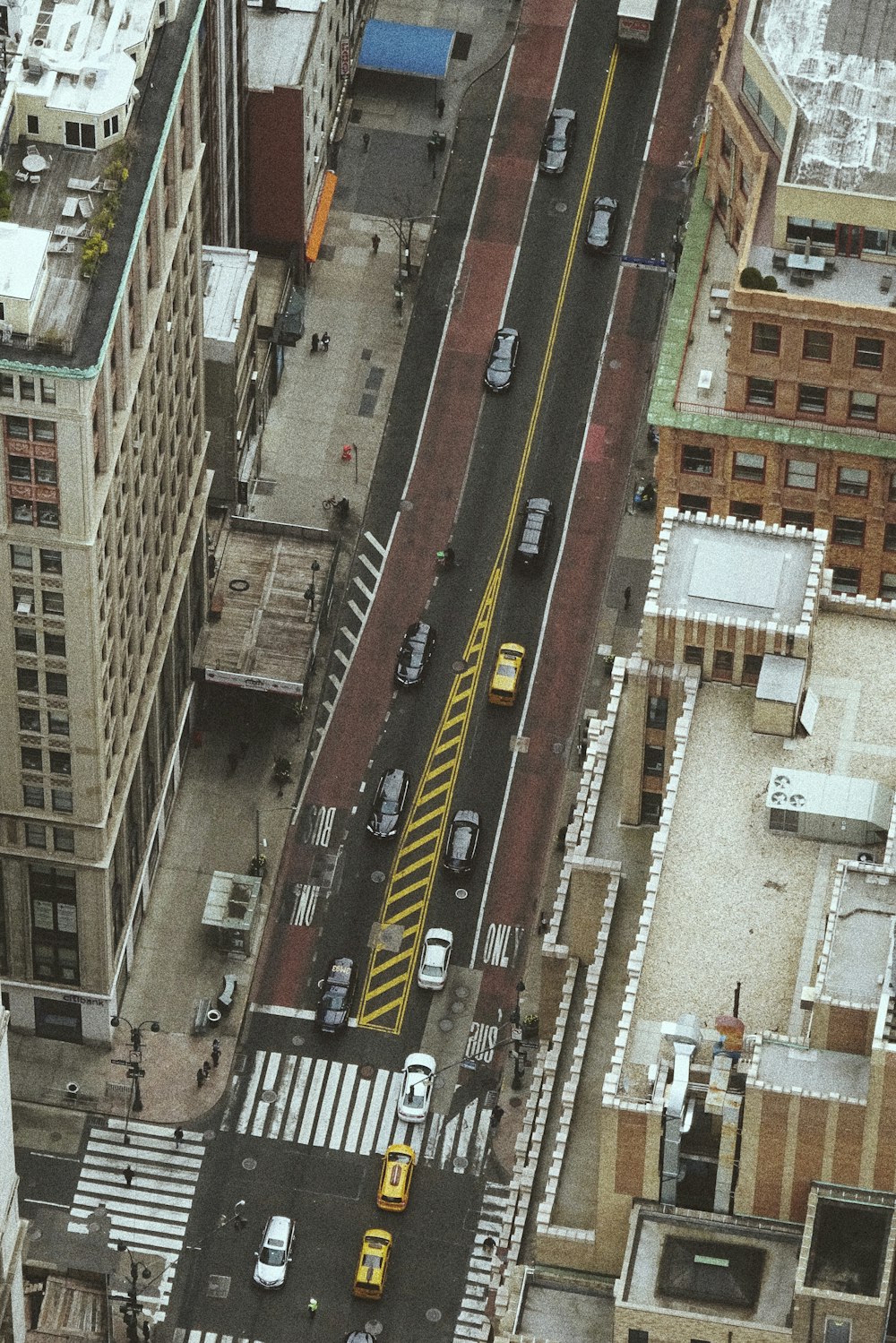 aerial photography of vehicles between buildings